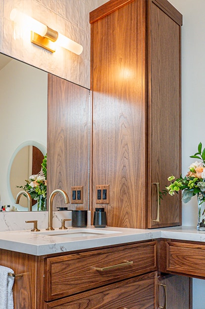A wood vanity with warm lighting