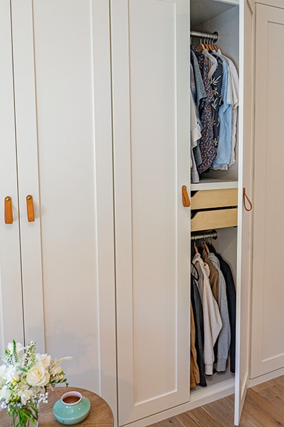 Flowers beside white cabinetry